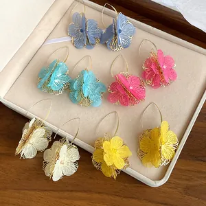 Detailed view of colorful hollow flower drop earrings in various vibrant shades.