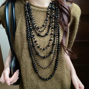 Close-up of elegant multi-layered black acrylic beaded long necklace for women