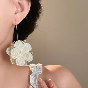 Detailed view of elegant hollow flower drop earring featuring delicate mesh petals and gold hook
