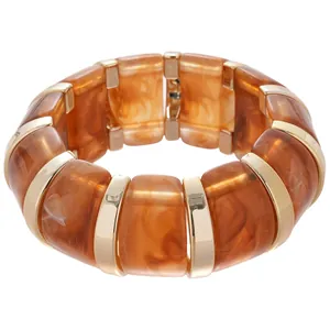 Stylish amber marbled acrylic bracelet featuring polished gold-toned metal splicing detail