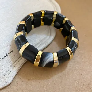 Chunky acrylic marbled patchwork bracelet with gold accents in black and white finish