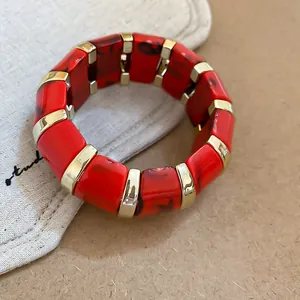 Elegant red marble acrylic stretch bracelet with polished gold-toned metal spacers