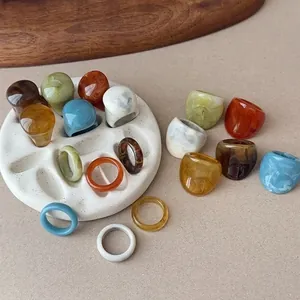 Diverse collection of vintage style resin geometric chunky rings and thin bands in various colors