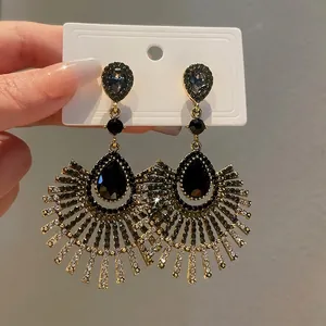 Elegant silver needle drop tassel earrings featuring black stones and shiny rhinestones