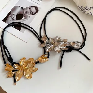 Vintage leather waist chain belt featuring detailed metallic tulip flower charms for women.