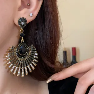 Close-up of elegant S925 silver needle teardrop tassel earrings with black rhinestones.
