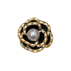 Elegant French style camellia flower brooch with pearl center and gold chain detail