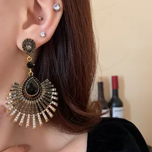Detailed view of elegant water-drop tassel earrings with sparkling rhinestones.