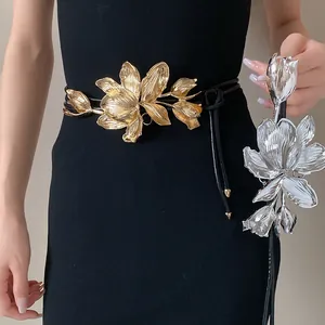 Detailed macro view of elegant gold and silver metal tulip leather waist chain belts
