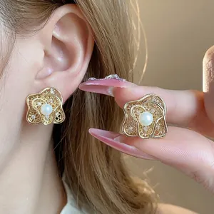 Elegant 18k gold plated flower-shaped clip-on earrings with central pearl accents