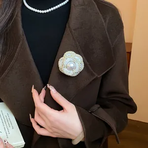 Elegant white camellia flower brooch with pearl center for chic coat and sweater (86 chars)
