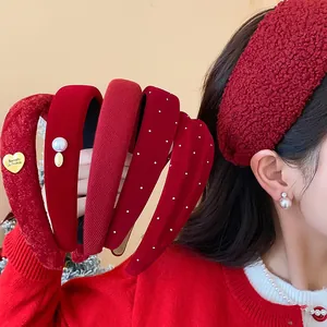 Detailed view of chic red flocked and pearl-decorated headbands for winter fashion