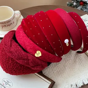 Variety of red velvet and knit headbands with pearl and gold heart details.
