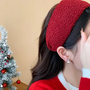 Close-up of a festive red textured wide headband hair accessory worn by a model