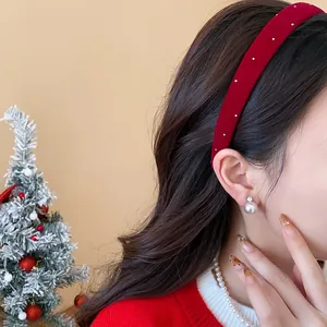 Side view of model wearing a red flocked headband with small white pearl accents