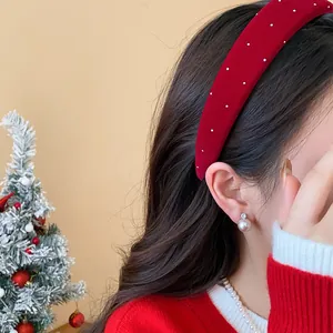 Close-up detail of an elegant red velvet padded headband with sparkling crystal accents