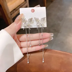 Close-up detail of stylish silver butterfly tassel earrings with elegant pleated texture design