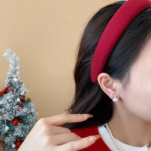 Detailed close-up of a stylish wide red flocked velvet headband for women at Christmas