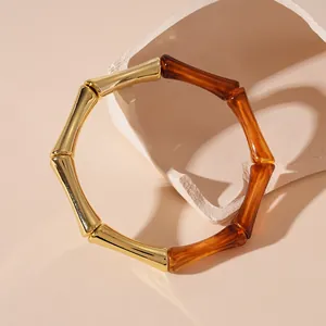 Elegante pulsera de eslabones de bambú con acabado dorado y segmentos de acrílico carey.