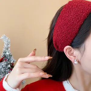 Detailed view of a red bouclé plush headband for a stylish high skull top look.