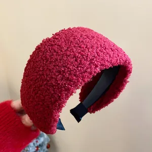 Detail view of a red plush wide headband with sherpa texture