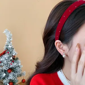 Detailed view of an elegant red flocked headband worn by a model in a festive setting