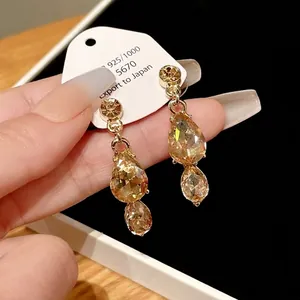Elegant vintage champagne gold teardrop crystal dangle earrings with flower stud detail
