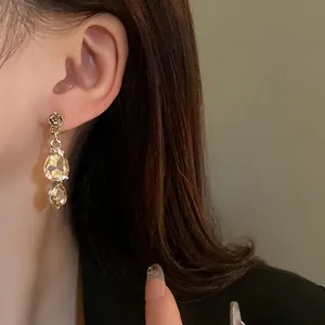 Vintage gold teardrop earrings with champagne faceted crystal rhinestones for women.