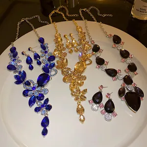 Detailed view of vintage crystal teardrop and floral necklace sets in multiple colors