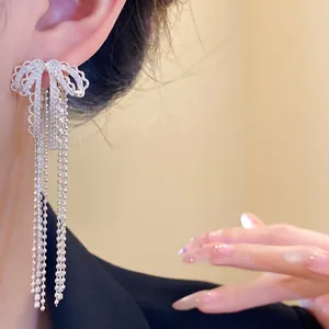 Elegant zircon bow tassel earrings shown as a close-up worn detail with sparkling finish