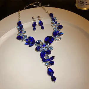 Detailed view of blue rhinestone floral teardrop necklace and earrings jewelry set