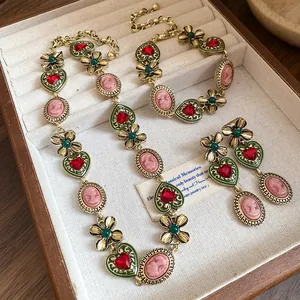 Vintage jewelry set with heart and flower motifs, including necklace, bracelet and earrings