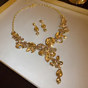 Close-up of champagne crystal flower necklace and earrings in vintage palace style