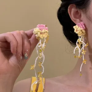 Handmade crochet flower tassel earrings featuring pink yellow blooms and white beaded dangles