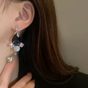 Close-up detail of vintage water-drop earrings featuring black and pink crystal clusters