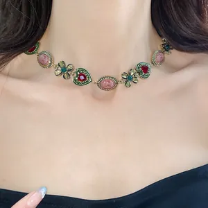 Elegant close-up of vintage gold heart and flower choker necklace on a model's neck.