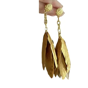 Elegant Bohemian gold feather drop earrings featuring textured round studs for women