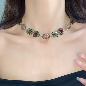 Vintage heart and flower choker necklace with colorful rhinestones and cameo relief detail