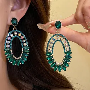 Vintage emerald green oval drop earrings with shimmering iridescent rhinestones for women