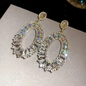 Detail view of vintage oval dangle earrings featuring shimmering colorful rhinestones