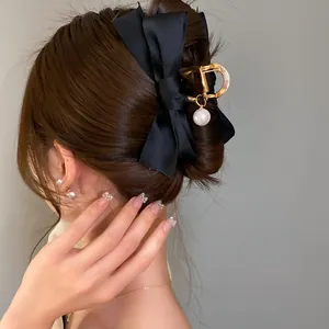 Elegante pinza per capelli con fiocco in raso nero, forma a D dorata e perla per chignon