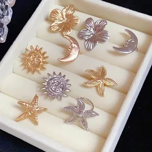 Collection of metallic sun moon and starfish ear clips in gold and silver finish