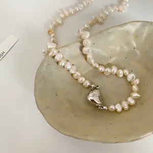 Detailed view of irregular freshwater pearl necklace with silver magnetic heart clasp