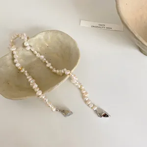 Close-up detail of irregular baroque freshwater pearl necklace with magnetic heart-shaped clasp