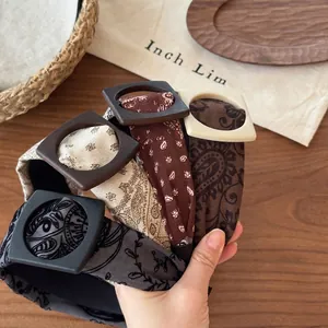 Detailed view of elegant patterned fabric headbands with retro wooden square buckles