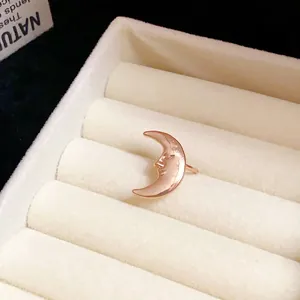 Rose gold crescent moon ear cuff with face profile shown in white velvet jewelry box.