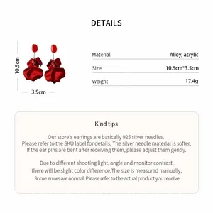 Detail view of red acrylic petal earrings with size and material specifications