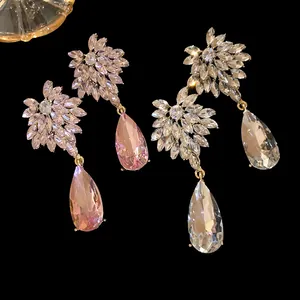 Macro view of exquisite crystal teardrop earrings with flower-shaped leaf stone clusters