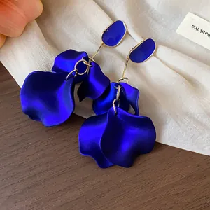 Elegant close-up view of royal blue acrylic petal drop earrings with gold finish detail