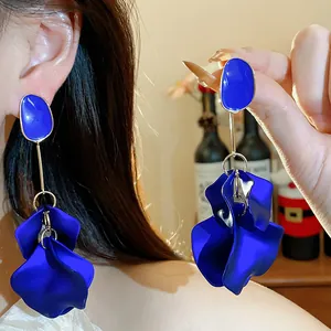 Close-up of elegant cobalt blue acrylic petal drop earrings shown on an Asian model